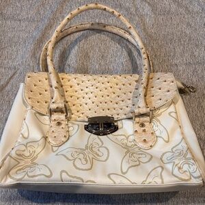 Marino Orlandi: Cream purse w/butterfly design. Hand straps